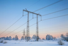 A Winter Dawn With Snow-covered Trees And A Power Line