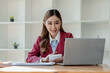 © kamiphotos - Numerical data is being presented for the accountant to calculate, Female accountant working about financial with calculator at her office, Savings, Finances and economy concept,