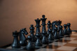 © 154K - Chess pieces on a wooden board on a dark background