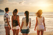 Group of young friends are standing at sea beach and watching at sunset