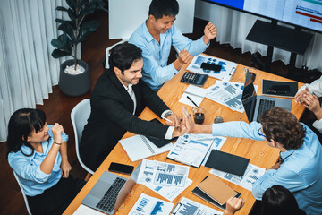 Cheerful meeting room, businesspeople celebrate with high fives and applause. Successful project was completed before the deadline, bringing joy and happiness to team. Meticulous