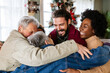 © NDABCREATIVITY - Happy multiethnic multi-generational family enjoying Christmas time together. People love concept.