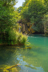 Wall Mural - The River Una below Milancev Buk waterfall at Martin Brod in Una-Sana Canton, Federation of Bosnia and Herzegovina. Located in Una National Park, it is also known as Veliki Buk or Martinbrodski