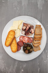 Wall Mural - toasts with chourico, cheese and olives on dish