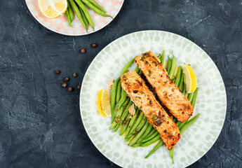 Wall Mural - Salmon roasted in an oven with vegetables.