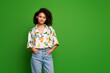 © deagreez - Photo of cute adorable lady wear print shirt standing hands pockets empty space isolated green color background