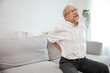 © offsuperphoto - senior man suffering from back pain on sofa