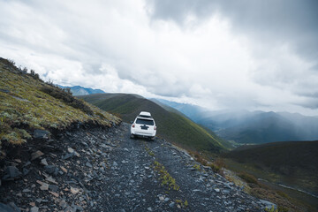 Wall Mural - Off road car on top of high altitude mountain trail, China