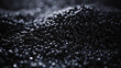 close up of a black surface, 3d black tiny plastic cylindrical grains , black plastic polymer pellets,polymer for pipes, Plastic and polymer industry, industry. Microplastic products.