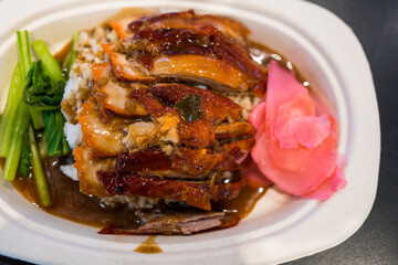 Wall Mural - Roasted bbq duck with gravy sauce on top of rice. Top view