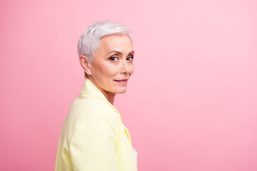 Canvas Print - Close up portrait of beautiful businesswoman in yellow jacket posing when someone calls her in office isolated on pink color background