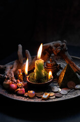 Witch altar with candles, old coins, stone runes, pentacle on dark background close up. Magic for attracting money, wealth. witchcraft. spiritual esoteric ritual for rich life. money magic.