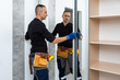 © Angelov - Furniture assembling. Professional worker installing cabinet at living room of new house.