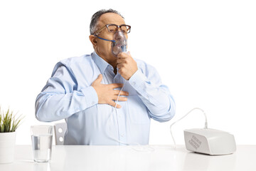 Mature man with chest problem using a nebulizer