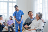 Fototapeta  - Asian young nurse support couple senior older man and woman in a wheelchair. elderly mature and a group of senior friends living in the hospital. socializing of retired people.