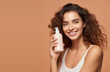 Girl applying hair conditioner. Woman holding bottle shampoo and conditioner. Beauty product, balm bottle. Young woman advertising care product. mock up, copy space.