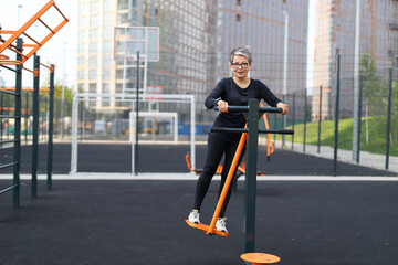 Poster - Active mature woman in sportswear, training outdoors for fitness and endurance, showcasing strength and motivation.