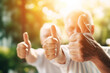 Happy elderly people show thumb up good, closeup of hands with sunlight, banner concept good pension