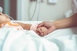 © PixelGallery - Mother hand holding child hand who have IV solution in the hospital with love and care