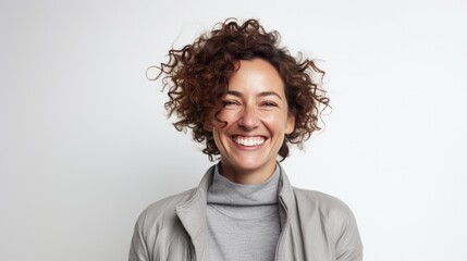 Poster -  smiling charming positive woman, happy joyful cheerful cute curly casual lady laughing having fun, looking at camera, standing isolated at white background, close up headshot portrait.