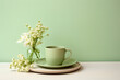 minimalistic still life with a mug and a bouquet of white flowers in pastel green, beige, brown tones.