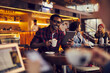 © Marko Geber - Smiling young man using tablet in cafe