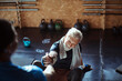 © Davor - Elderly Man with Personal Trainer in Gym