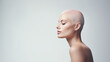 Beautiful young woman with bald head after chemotherapy on isolated white background, World Cancer Day.