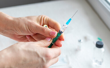 Close upshot of the woman preparing medicine for injection. Healthcare