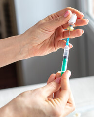 Close upshot of the woman preparing medicine for injection. Healthcare