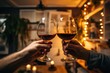 © NikoG - Hands toasting with wine in cozy home interior