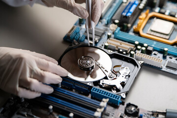 person in gloves work in laboratory, repair broken hdd hard drive