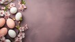 Easter eggs and cherry blossoms on a pale purple background with copy space