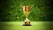 Golden trophy cup on lush green grass background. Sports victory and nature concept. Generative AI