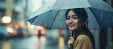 Beautiful Woman Posing Using An Umbrella In The Rain.