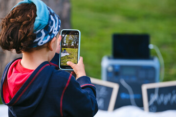 Kid taking a picture with the phone. 