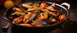 Mussels in tomato sauce cooked in a stainless steel pan.