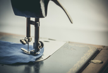 Poster - Vintage sewing machine, man sews on a vintage sewing machine, retro sewing machine