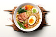 Ramen noodle soup with pork, egg and vegetables on wooden background. Top view