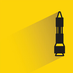 Wall Mural - missile icon with shadow on yellow background