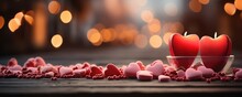 Two Candles Burning Brightly On A Reflective Surface, With A Multitude Of Small Hearts Scattered Around, All Set Against A Backdrop Of Golden Bokeh.