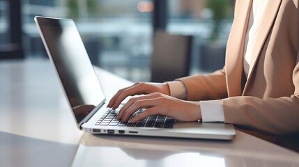 Close up of female entrepreneur’s hands using laptop to work and research business information