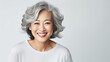 A closeup photo portrait of a beautiful old mature Asian American woman smiling with clean teeth. for a dental commercial. lady with stylish hair and skin care, template 