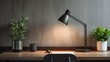 A minimalist office corner with a sleek desk, task lamp, and a potted plant creating a productive work environment.