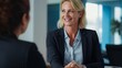 Handshake between smiling businesswoman and client at office meeting. Mid aged female manager or hr hiring new recruit, bank or insurance agent, or lawyer making contract deal at work