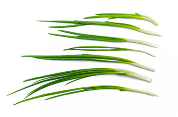 Wall Mural - Top view of rows of green onions on white background isolated. Concept of healthy eating.