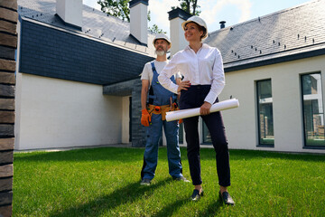 Team of building experts conducting construction object inspection outdoors