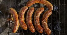Delicious Juicy Sausages, Cooked On The Grill With A Fire.