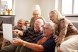 © Davor - Group of senior people laughing at laptop from home