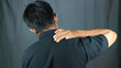 © Aufa Fahmi  - Close-up rear view of man's hand touching shoulder pain, shoulder pain concept.
